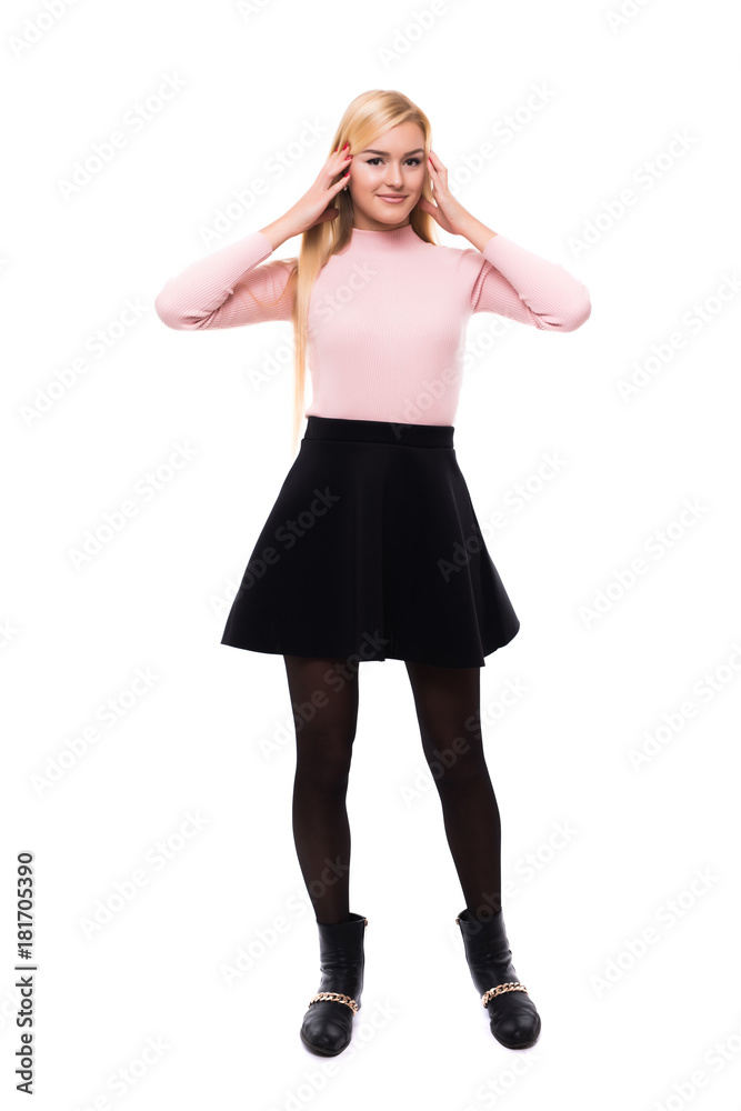 Attractive young fashion model wearing dress in studio and smiling Attractive young fashion model wearing dress in studio and smiling