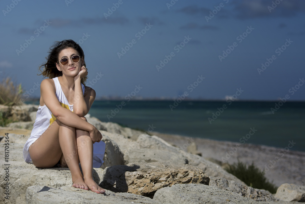 Beautiful young woman enjoying nature by the sea Beautiful young woman enjoying nature by the sea
