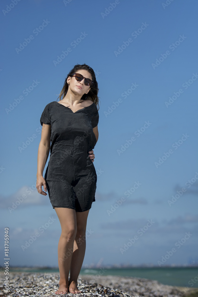 Beautiful young sexy woman enjoying nature by the sea Beautiful young sexy woman enjoying nature by the sea