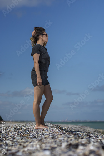 Beautiful young woman enjoying nature by the sea