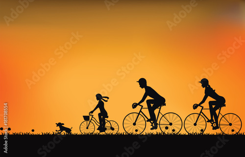 Silhouette of family driving bike with beautiful sky at sunset .