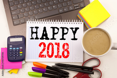 Word writing Happy 2018 in the office with surroundings such as laptop, marker, pen, stationery, coffee. Business concept for Holiday Celebration Workshop white background with copy space