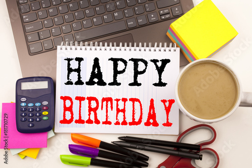 Word writing Happy Birthday in the office with surroundings such as laptop, marker, pen, stationery, coffee. Business concept for Anniversary Celebration Workshop white background with copy space
