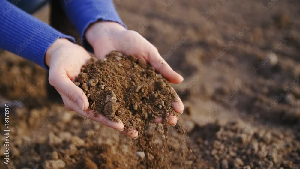 Hands dropping farm field soil close up slow motion 4K