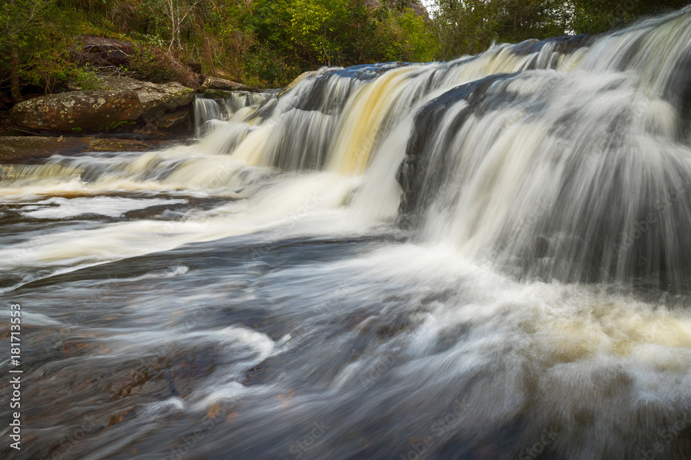 Fototapeta premium View of peaceful waterfall in the tropical rainforest, waterfall in Phu Kradueng National Park, Loei Province, Thailand