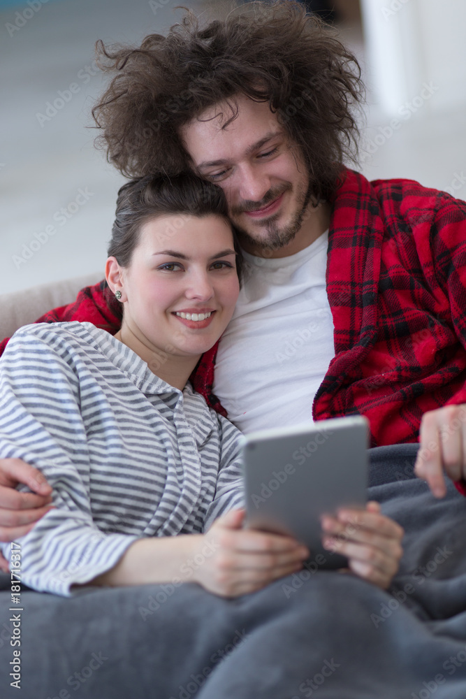 couple relaxing at home with tablet computers couple relaxing at home with tablet computers