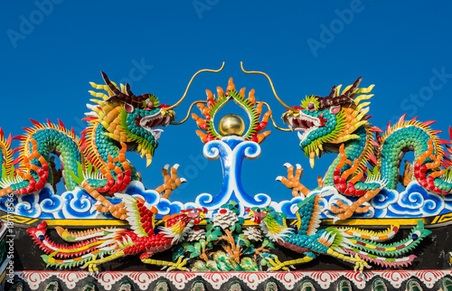 Twin chinese dragon statue on the roof of chinese temple