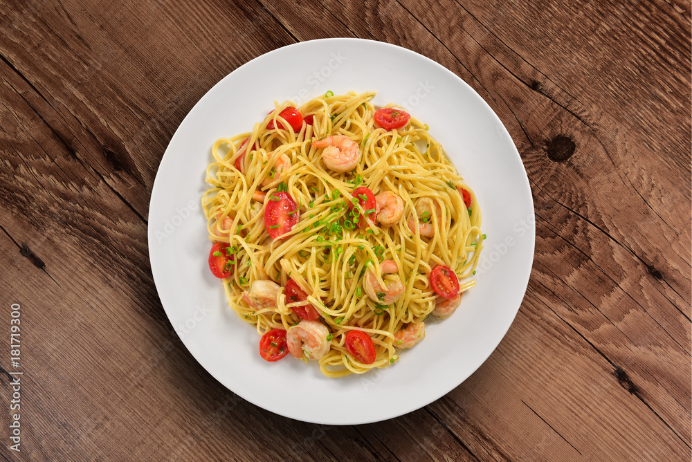 Shrimp spaghetti plate on wooden background Shrimp spaghetti plate on wooden background