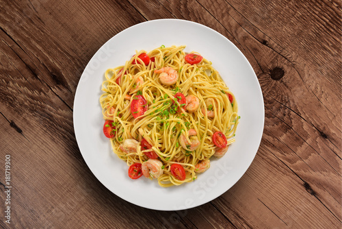 Shrimp spaghetti plate on wooden background