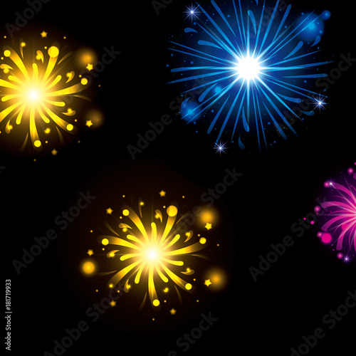 fireworks bursting in glowing colours yellow blue magenta on black background