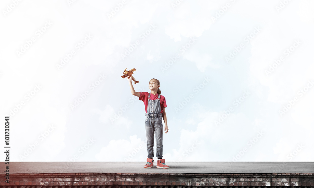 Concept of careless happy childhood with girl dreaming to become Concept of careless happy childhood with girl dreaming to become
