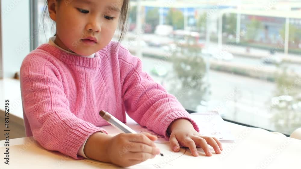 little girl doing homework study indoor by the window little girl doing homework study indoor by the window