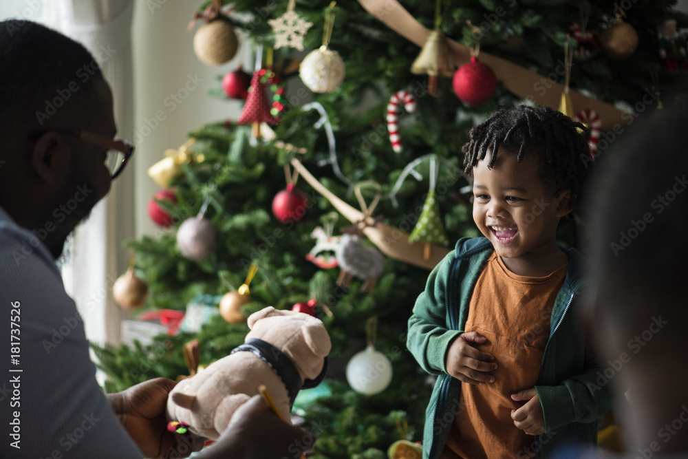 Happy little kid receiving a Christmas present Happy little kid receiving a Christmas present