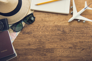 Traveling gadgets on wood table background, top view border design with copy space