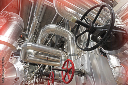 Equipment, cables and piping as found inside of a modern industrial power plant