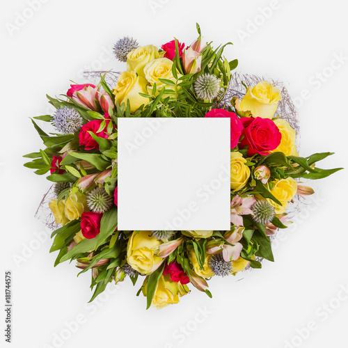 Creative layout made of flowers and leaves with paper card note. Flat lay