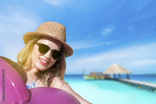 beautiful girl enjoys swimming in the ocean on an inflatable circle on the Maldives on a sunny day © sweethelen