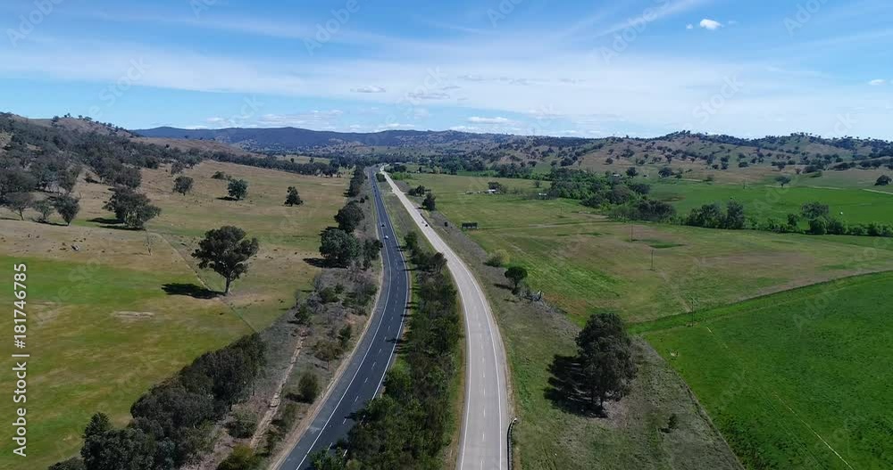 M31 hume highway multi-lane interstate road from Sydney to Melbourne with passing traffic in regional NSW between hill ranges and agriculture farms.
M31 hume highway multi-lane interstate road from Sydney to Melbourne with passing traffic in regional NSW between hill ranges and agriculture farms.