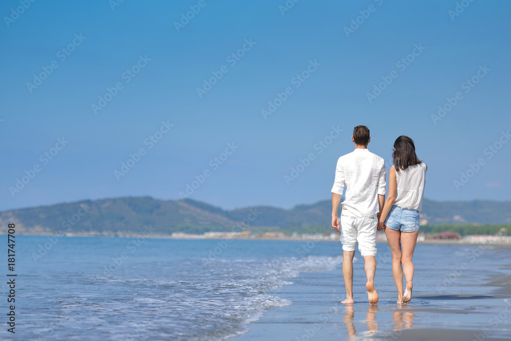 Young happy couple on white beach at summer vacation