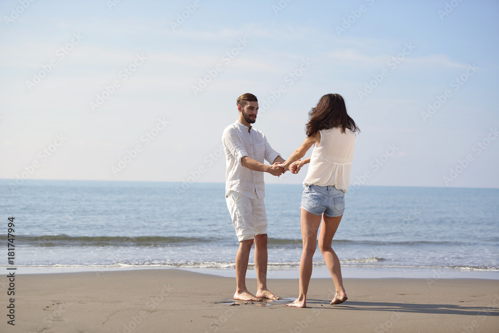 happy young romantic couple in love have fun on beautiful beach at beautiful summer day.