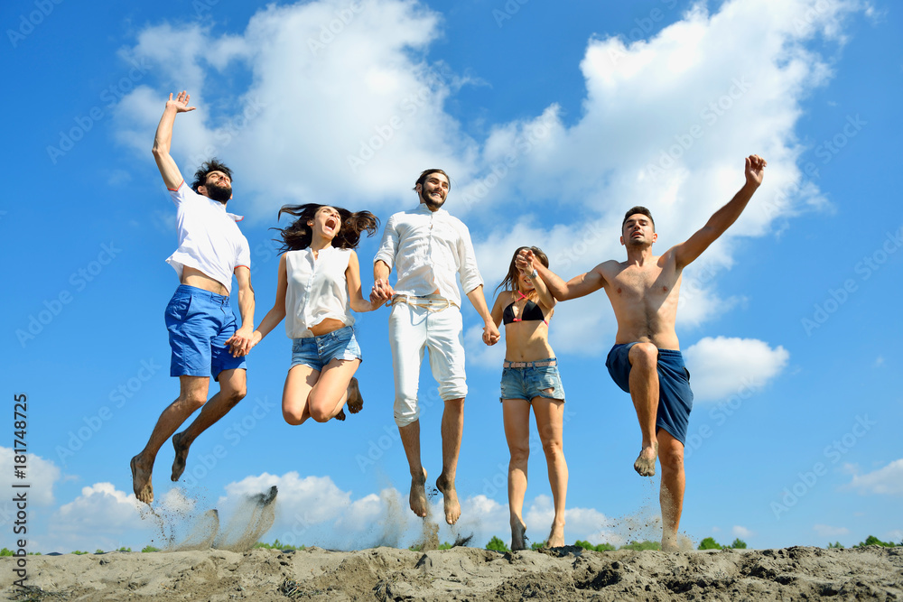 Image of young people jumping together outdoor. Image of young people jumping together outdoor.
