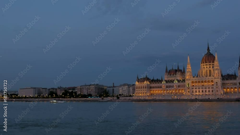 Wide pan to the Hungarian Parliament in Budapest during twilight. The building is all lit up Wide pan to the Hungarian Parliament in Budapest during twilight. The building is all lit up