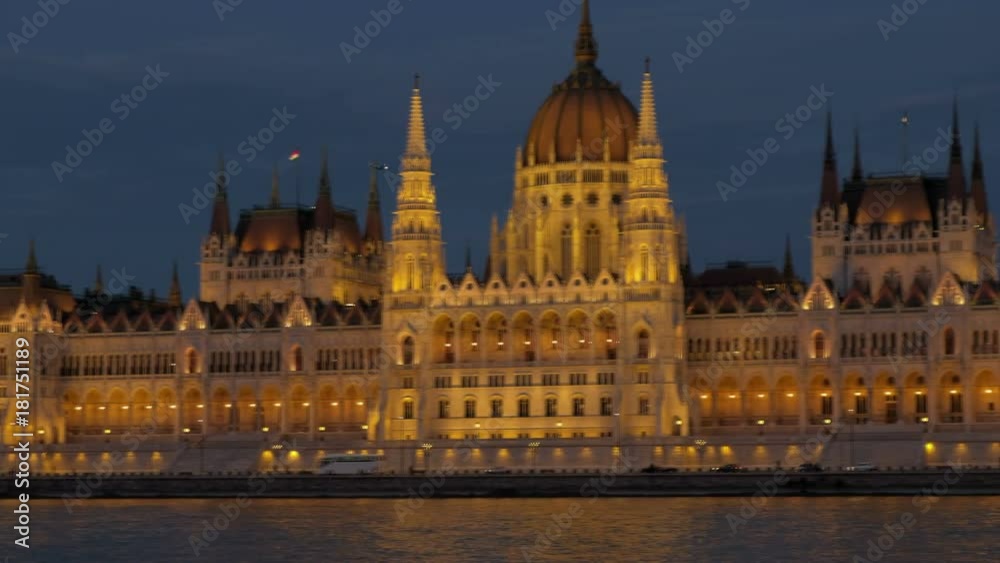 Pan across the facade of the Hungarian Parliament in Budapest during twilight. The building is all lit up Pan across the facade of the Hungarian Parliament in Budapest during twilight. The building is all lit up