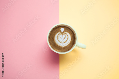 coffee cup with cappuccino on pastel background top view