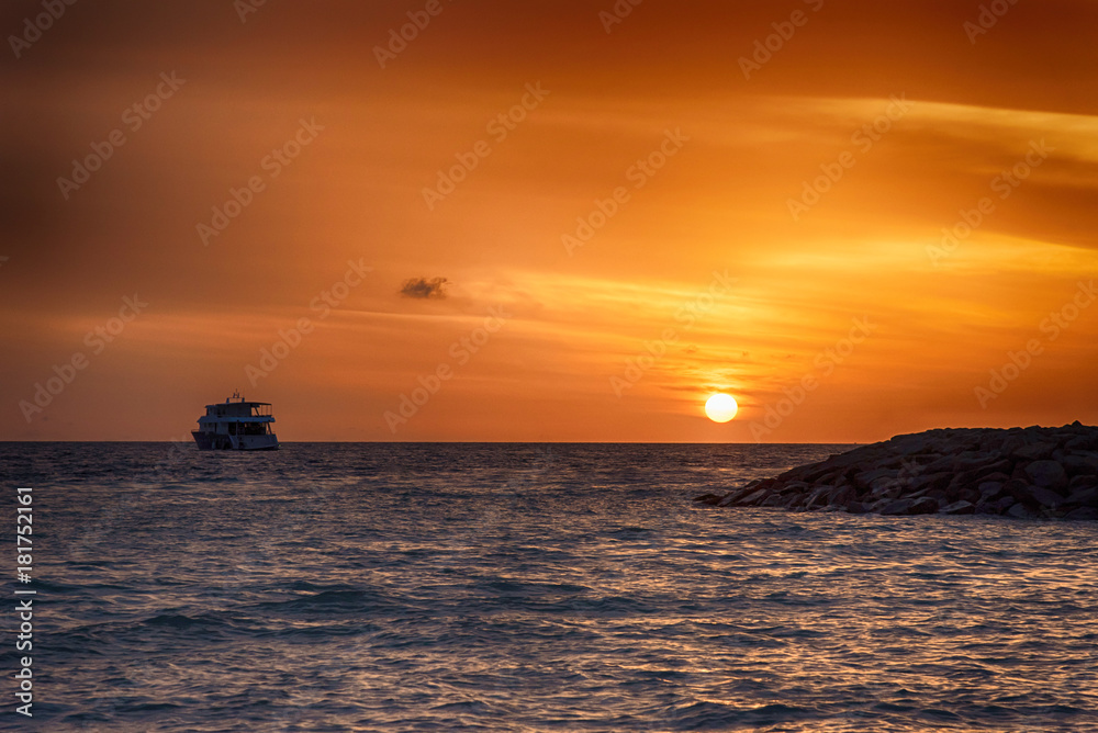 Sunset in the Maldives. Beautiful colorful sunset over the ocean at Maafushi island,Maldives Sunset in the Maldives. Beautiful colorful sunset over the ocean at Maafushi island,Maldives