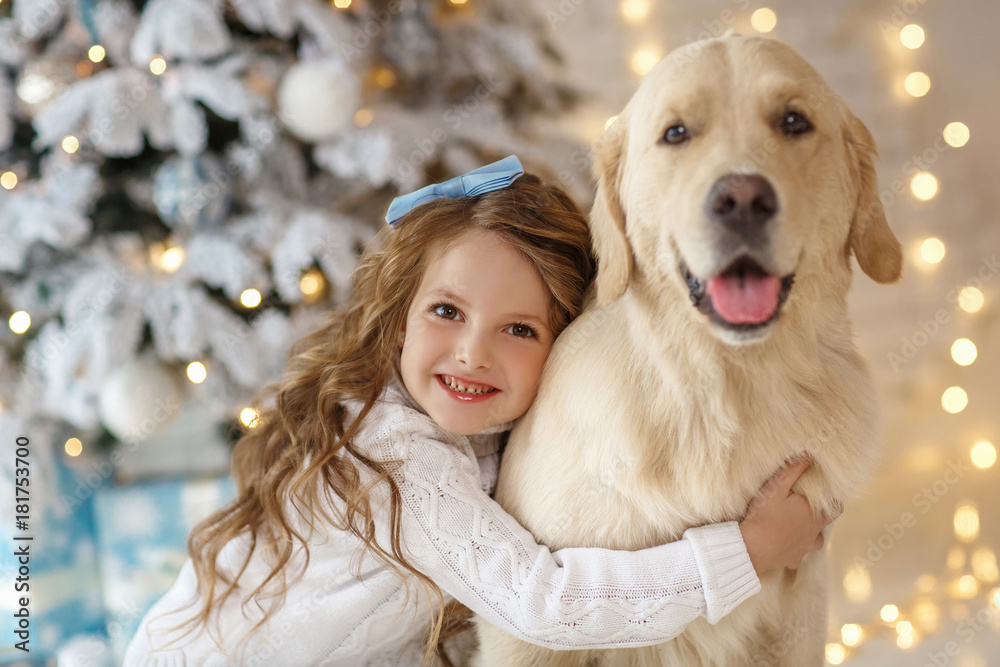 Little cute girl with a golden retriever dog 