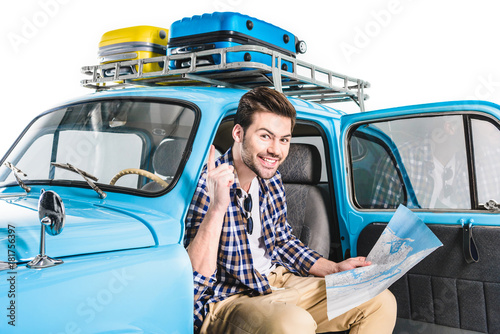 man sitting in car with map