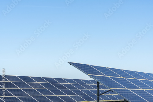 Commercial solar panels on bright day in the English countryside