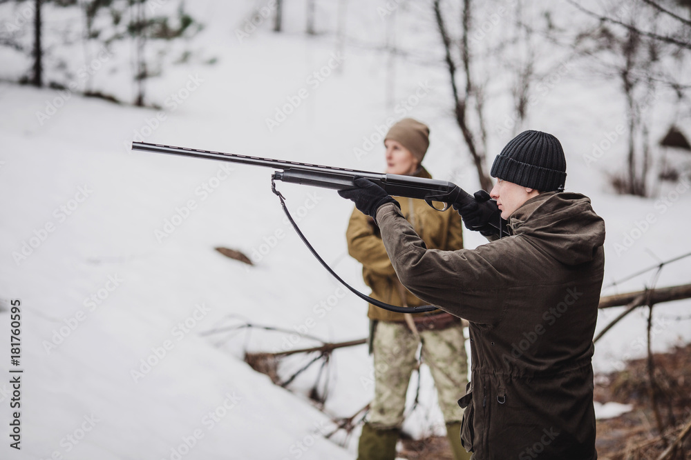 male hunter with binoculars ready to hunt, holding gun and walking in forest. male hunter with binoculars ready to hunt, holding gun and walking in forest.
