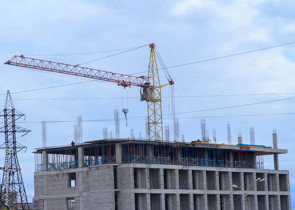 Building under construction against crane. Building under construction against crane.
