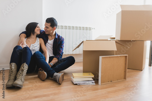 Cheerful pair sitting in boxes