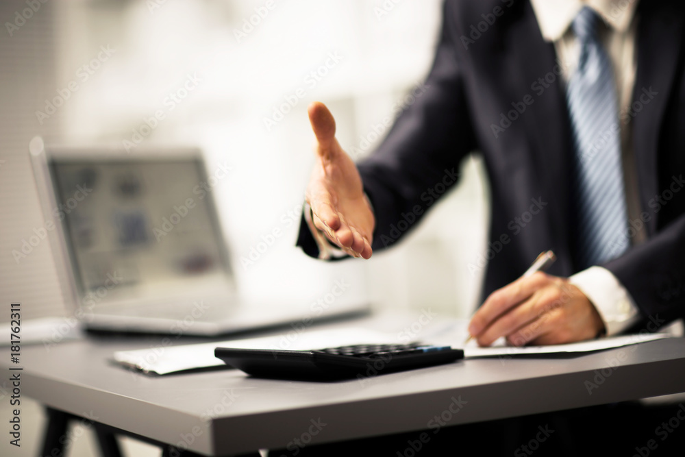 Portrait of successful businessman giving a hand for the transaction Portrait of successful businessman giving a hand for the transaction
