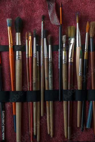 Painter's brushes professional case. Close up. Vertical composition.