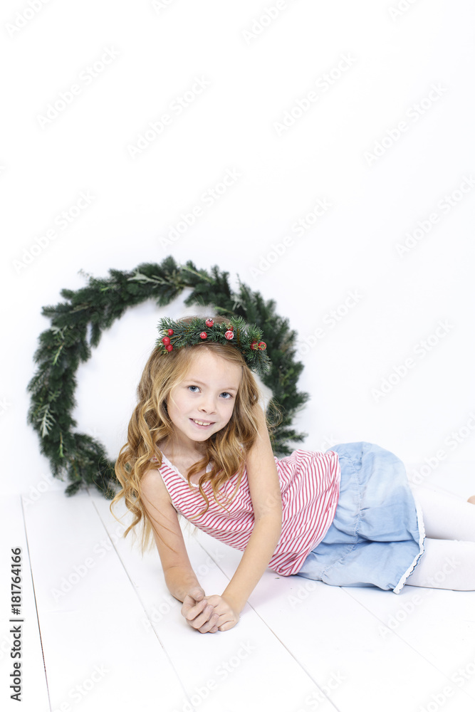 Happy beautiful girl with a christmas wreath