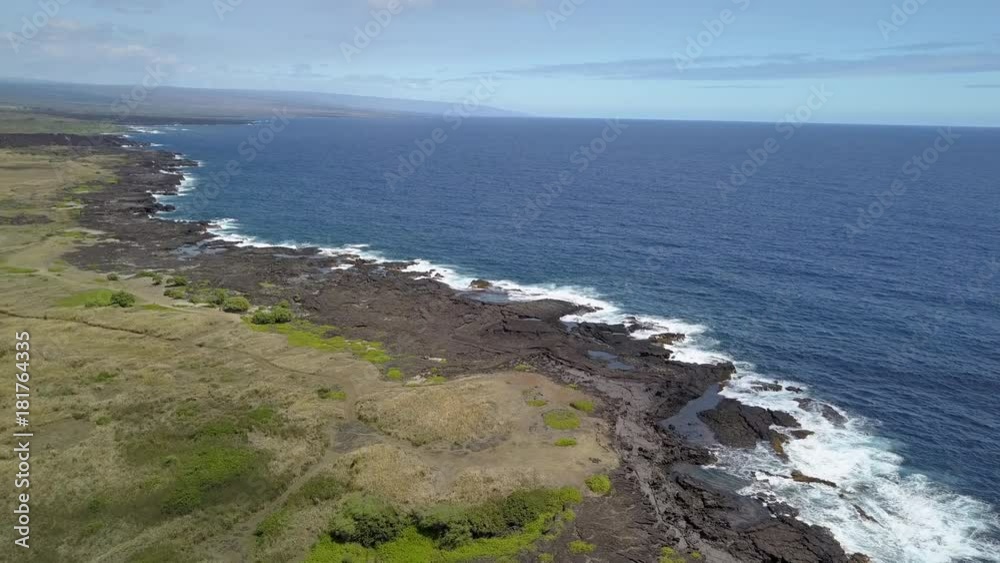 panning landscape shot of coastline and beautiful blue ocean on a sunny day on the Big Island in Hawaii panning landscape shot of coastline and beautiful blue ocean on a sunny day on the Big Island in Hawaii