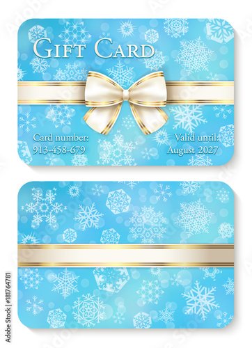 Luxury baby blue Christmas gift card with white snowflakes in background and cream ribbon as decoration
