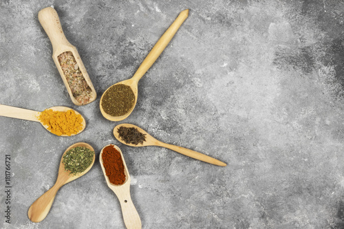 Various spices on a gray background. Top view, copy space. Food background