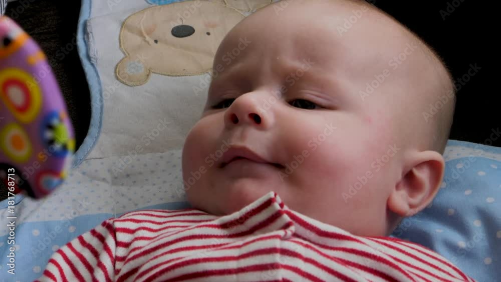 Exams of a three-month-old baby while playing and taking a feeding bottle Exams of a three-month-old baby while playing and taking a feeding bottle