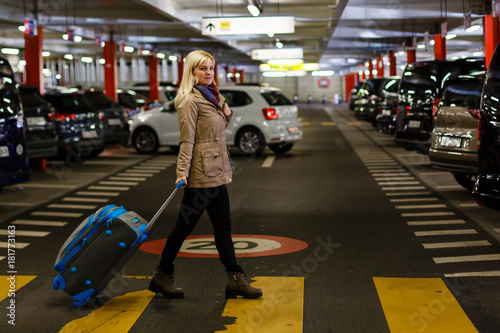 Young woman with travel bag and walking at the parking airport ready for travel. concept. lifestyle © Angelov