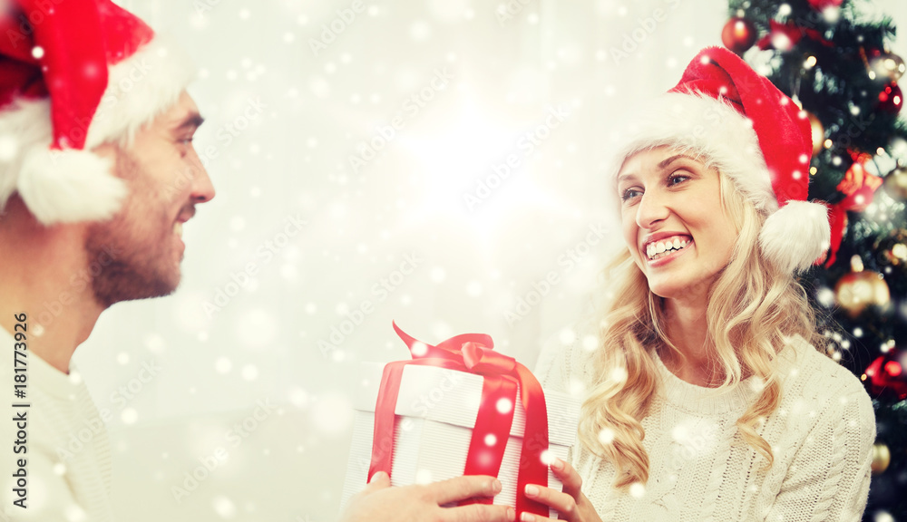 happy couple at home with christmas gift box happy couple at home with christmas gift box