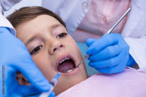 Cropped image of dentist examining boy