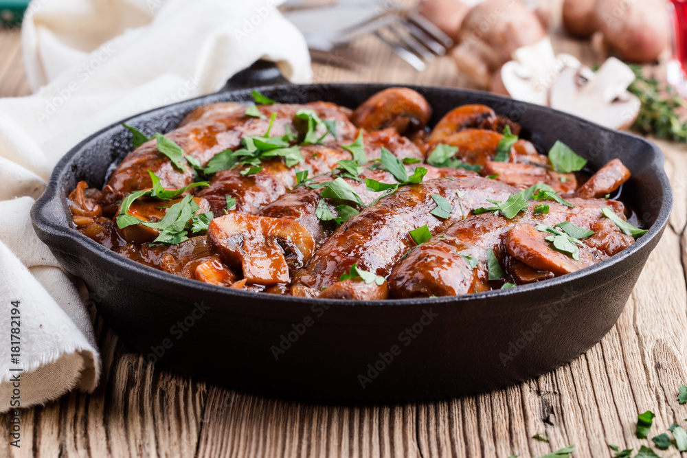 Sausages with onion and mushrooms gravy