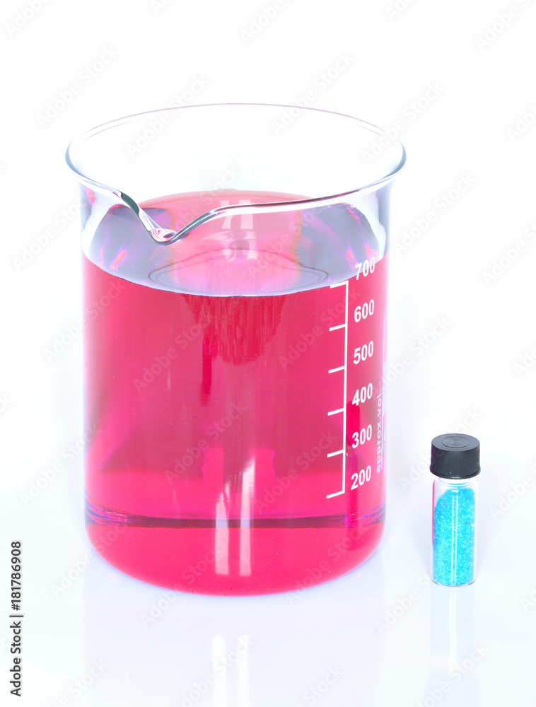 Chemical beaker with red chemicals and crystals of bluestone Chemical beaker with red chemicals and crystals of bluestone