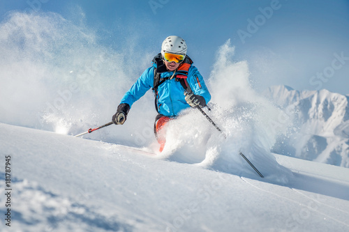 Male freeride skier in the mountains off-piste photo