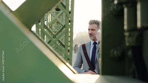 Wallpaper Mural Mature businessman with a smartphone in a city. Torontodigital.ca