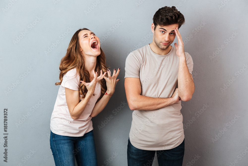 Portrait of a upset young couple having an argument - obrazy, fototapety, plakaty 